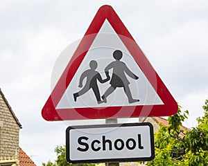 Caution Children Crossing Sign near a School in the UK