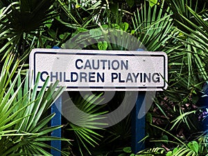 Caution Children Playing Wooden Post Sign In Trees