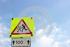 Caution children Road sign in yellow frame over bright