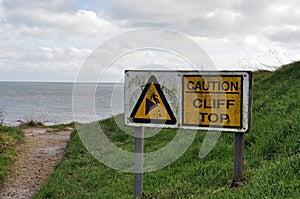 Caution cliff top sign