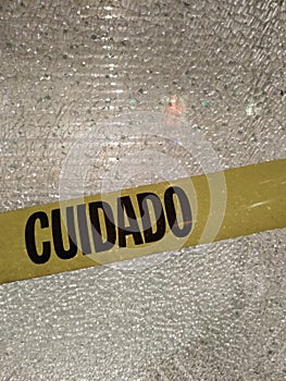 Caution, Cuidado, Caution Tape In A Broken Window