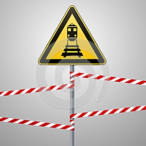 Caution - danger Warning sign safety. Beware of the train. A yellow triangle with a black image. The sign on the pole and protecti