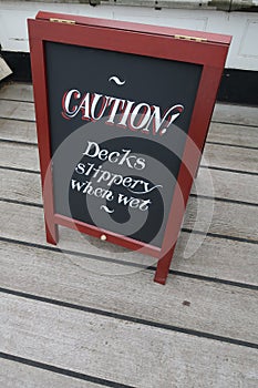 Caution decks slippery when wet sign.