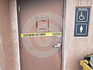 Caution do not enter yellow tape on bathroom door and sign