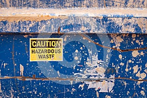`Caution, Hazardous waste` sticker sign.