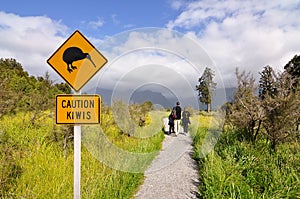Caution kiwi panel on a trail