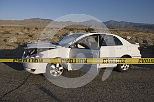 Caution Ribbon With Damaged Car