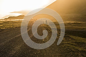 Caution Sign on Gravel Road with Golden Sunset in Stokksnes, Ice