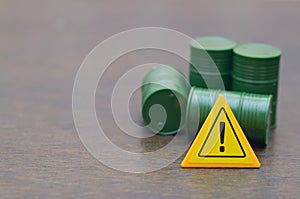 Caution Sign with Green Barrels Symbolizing Hazardous Waste and Environmental Risk