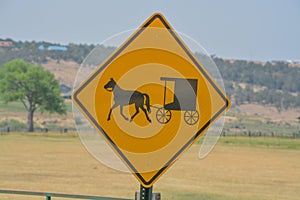 A caution sign to watch for horse drawn carriages on the roadway in Colorado