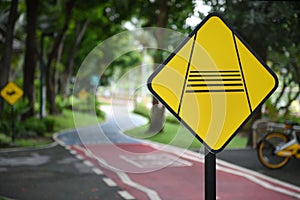 Caution slow down rider traffic sign and bike lanes