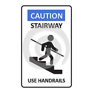 Caution stairway Use Handrails sign. A man goes down the stairs and holds on to the handrail. A sign warning of danger