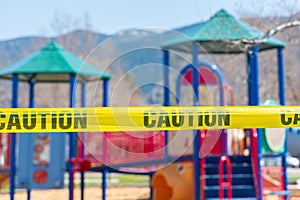 Caution tape blocking off children`s playground during COVID-19 pandemic