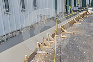 Caution Tape Guards A Freshly Poured Concrete Sidewalk