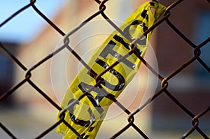 Caution tape tied to a chain-link fence outside of an elementary school in Winnipeg, Manitoba photo