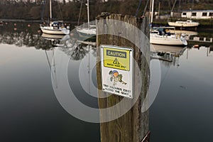 Caution trip hazard, watch your step, sign on the quayside in Caernarfon, Wales.