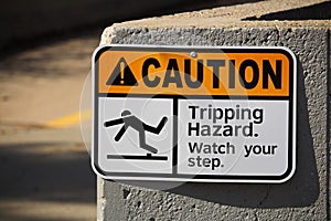 Caution tripping hazard sign on a wall