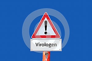 Caution warning sign virologists on blue background photo