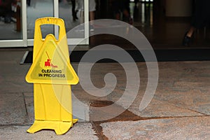 Caution Wet Floor in front of Building Gate