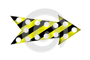 Caution yellow and black stripes painted over a vintage bright and colorful illuminated metallic display arrow sign with bulbs