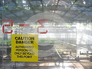 Caution yellow sign at commercial greenhouse