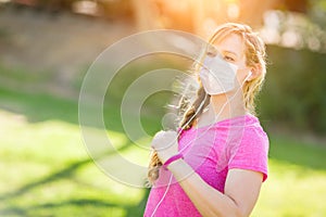 Cautious Girl Wearing Medical Face Mask During Workout Outdoors