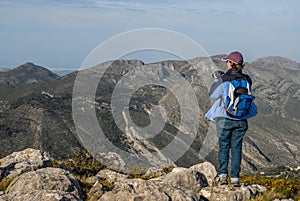 Cavall Verd, woman and landscape view over rocks and mountains photo
