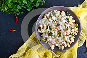 Cavatappi pasta with broccoli, red pepper and cream sauce in a bowl. Vegetarian dish. Delicious wholesome food. Proper nutrition.