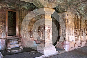 Cave 4 : Interior view. The figure of Mahavira in the sanctu is partially seen, Jaina Tirthankara images engraved on the pillars a