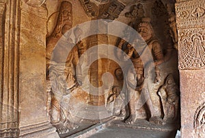 Cave 3 : Carved figure of Vishnu as Narasimha, half human, half lion, on the right and Harihara, a syncretic sculpture of Vishnu a photo