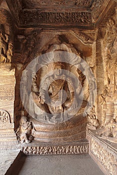 Cave 3 : Carved figures of Vishnu seated on a hooded serpent called Sesha or Ananta on the eastern side of the verandha. Badami Ca photo