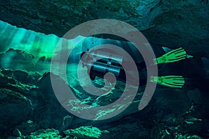 Cave Diver in Light Rays in a Cenote photo