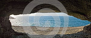 Cave at the edge of the sea photo