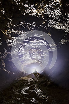 Cave entracne with light and stalagmite