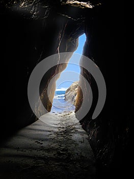 Cave entrance by ocean in vertical layout