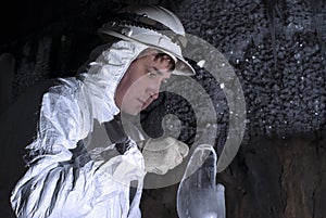 The cave explorer looks at the icy stalagmite