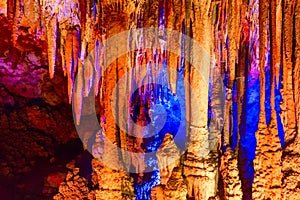 Cave illuminated stalactites and stalagmites