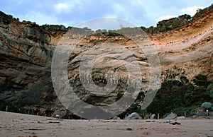 A cave in the rock wall of Loch Ard Gorge