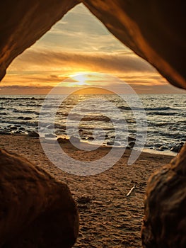 Cave\'s Eye View: Sunset Spectacle at Veczemju Klintis Beach