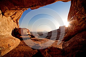 Cave and sunset in the desert mountains photo