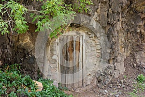 A cave with a wooden door at a ghost town in new mexico