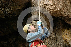 Caver abseiling in a pothole.