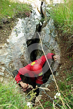 Caver descends in a cave