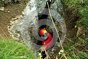 Caver descends in a cave