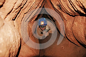 Caver in a narrow passage photo