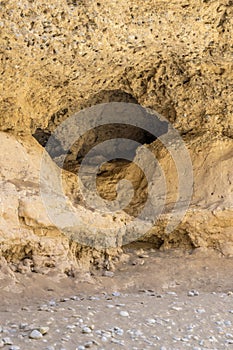 cavern hole in sandstone cliffs at narrow Serisem canyon, Naukluft desert, Namibia