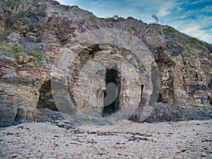 Caves in eroded mudstone cliffs at Runswick Bay in North Yorkshire, UK