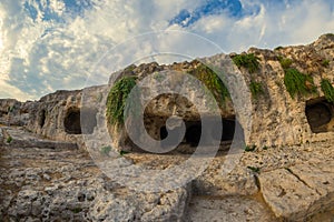 Caves located above the Greek Theatre, Neapolis Archaeological Park, Siracusa, Sicily, Italy