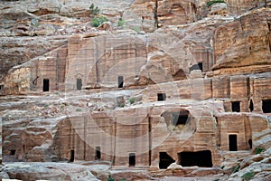 Caves in Petra, Jordan - ancient Nabatean city in red natural rock and with local bedouins, UNESCO world heritage