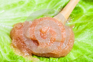 Caviar of alaska pollock in wooden spoon on leaf